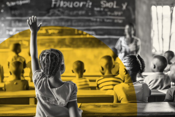 Teacher and students smiling in a school, Village Schools International, community, sustainable schooling